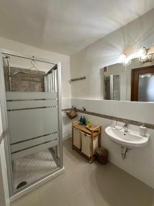 a bathroom with a shower and a sink at DOMMO ASULETTA in Bosa +114 photos