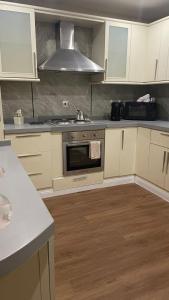 a kitchen with white cabinets and a stove top oven at ڤيلا المرجان للعائلة Murjan Family Villa in Yanbu