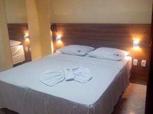A bed or beds in a room at Estação Hotel