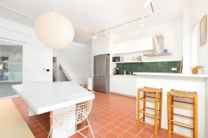 a kitchen with a white table and two chairs at Milnamour, Whole House by the Sea with Parking in Hvar