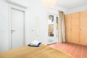 a bedroom with a bed with a phone on it at Milnamour, Whole House by the Sea with Parking in Hvar