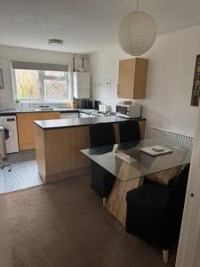 a kitchen with a table and a counter top at Large 2 bedroom house in Wombridge