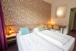 Letto o letti in una camera di Hotel Madeleine Biohotel