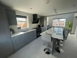 a kitchen with blue cabinets and a white counter top at Newton house in Burton Fleming +40 photos