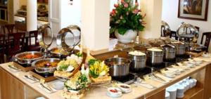 a buffet with many pots and pans of food at Aloha Hotel in Quy Nhon