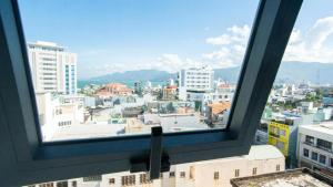 a view of a city from a window at Aloha Hotel in Quy Nhon