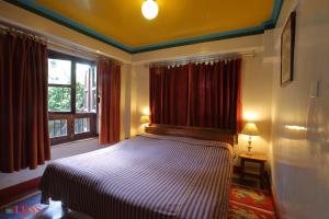 Voodi või voodid majutusasutuse Vajra Hotel toas