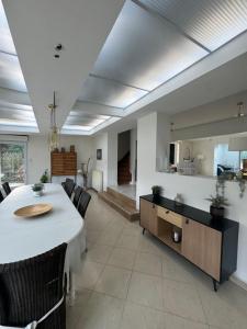 a dining room with a table and some chairs at Les Villas de Puys - Dieppe in Dieppe