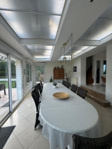 a dining room with a white table and chairs at Les Villas de Puys - Dieppe in Dieppe