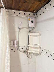 a shower in a bathroom with a mirror at บ้านเชิงเขา โฮมสเตย์ in Ban Mai