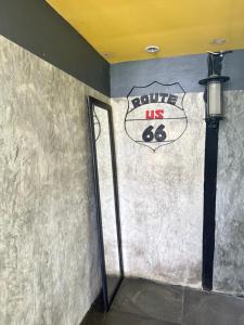 a door in a room with a sign on the wall at บ้านเชิงเขา โฮมสเตย์ in Ban Mai