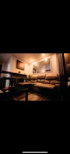 a living room with a couch and a table at Philippine Arena Staycation in Marilao Bulacan in Marilao +4 photos