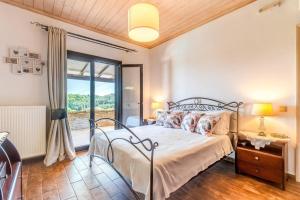 a bedroom with a bed and a window at Villa Antinoti in Agía Aikateríni +24 photos