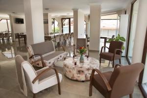 a lobby with chairs and a table with flowers on it at Yasemin Hotel in Özdere