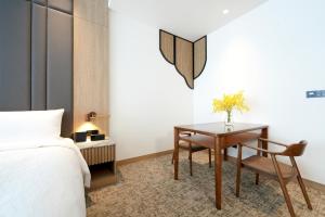Ένα ή περισσότερα κρεβάτια σε δωμάτιο στο Izumi Boutique Hotel