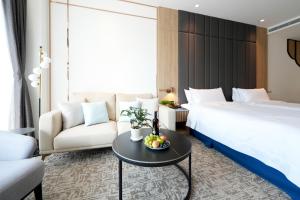 Ένα ή περισσότερα κρεβάτια σε δωμάτιο στο Izumi Boutique Hotel