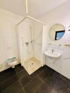 a bathroom with a shower and a toilet and a sink at Ferienhaus Usedom - Haus Andrea - 300Meter zur Ostsee in Ostseebad Koserow
