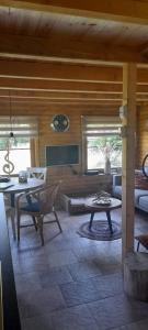 a living room with a couch and a table at Green Village House in Ganna