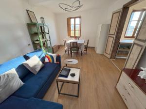 a living room with a blue couch and a table at Casa Nico and Vico in Scalea