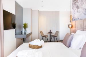 a bedroom with a bed and a table with chairs at Fly Room - S5 - MPolo in Medulin +19 photos