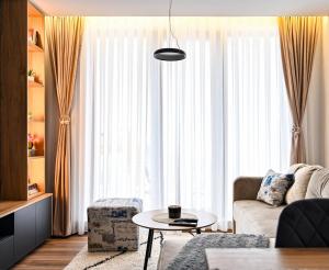 a living room with a couch and a table at Zeleni vrh A03 in Kopaonik