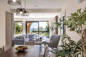 a living room with a table and chairs at Ayia Napa Seafront Ionion Villa H5 in Ayia Napa