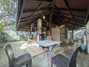 an outdoor patio with a table and chairs at Urbiz Garden Bed and Breakfast in san juan la union +58 photos