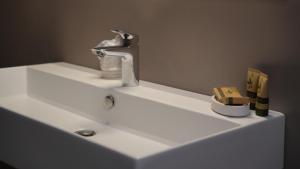 a sink with a faucet on top of it at Residence La Colombera in Riva del Garda