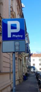 a blue parking sign on the side of a street at Hotel Logos Kraków in Krakow