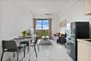 a kitchen and living room with a table and a refrigerator at Privo by Kozystay - BSD in Tangerang