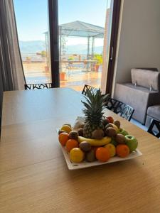 a plate of fruit on a table with a view at Roof Apartment in Somma Vesuviana