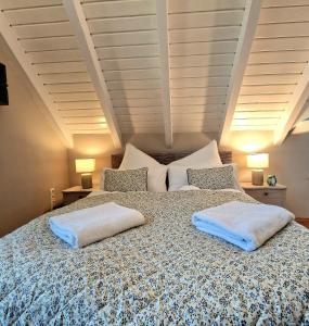 a bedroom with a large bed with two pillows on it at Select-Home 6 - Ferienhaus, Altstadt & Stadtpark in Neunburg vorm Wald