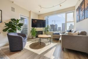 a living room with a couch and a table at Your Urban Oasis in the Heart of Little Italy in San Diego