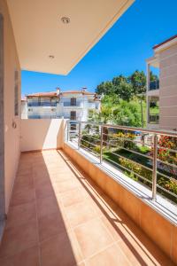 a balcony with a view of a building at Darina central Accommodation in Pefkohori