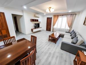 a living room with a couch and a table at HAMPTONS Apartments in Phnom Penh