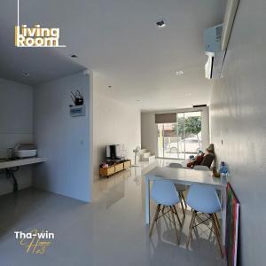 a kitchen with a table and two stools at NEW! Tha-win home3 #10minLeegarden #minDimsumChabura in Sathani Hat Yai
