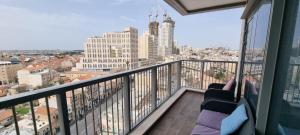 a balcony with a view of a city at Savyon View Royal Suites - Alefimmoed in Jerusalem