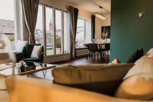 a living room with a couch and a table at The Penthouse Basel in Basel