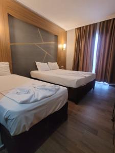 a hotel room with two beds and a window at Hotel Dionisus Spa Resort in Belek +30 photos