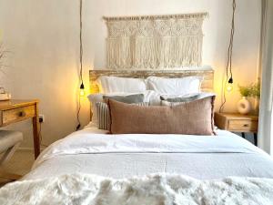 a bedroom with a bed with white sheets and pillows at Signal Rest in Swindon