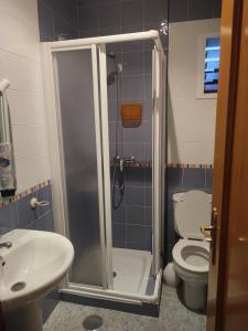 a bathroom with a shower with a toilet and a sink at Centro Isla Cristina in Isla Cristina +14 photos