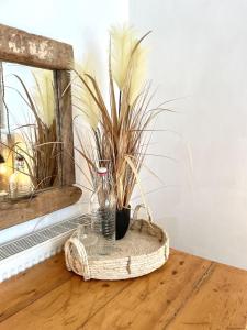 a vase sitting on a wooden table with a plant at Signal Rest in Swindon +8 photos
