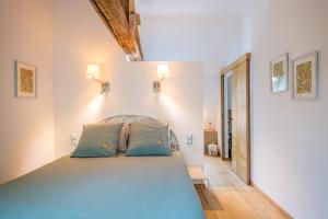 a bedroom with a large bed with blue pillows at Chambre rénovée en 2024 avec cuisine-séjour-salon partagés in Bessé-sur-Braye