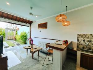a living room with a table and a couch at Sejati Villas - Petitenget in Seminyak