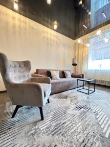 a living room with a couch and a table at EVIS LTD apartments 1 in Rēzekne