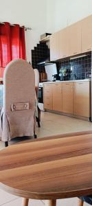a kitchen with wooden cabinets and a table and chairs at Iraklitsa Teo Resort in Iraklitsa +5 photos