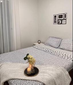 a bedroom with two beds and a vase on a table at Luxe Central Living Apartment in Debrecen +11 photos