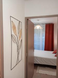 a door to a bedroom with a bed and a mirror at B010 Appartement Disneyland Paris France in Montévrain