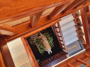 an overhead view of a window with a cross and plants at Maison Saiko Angkor Boutique in Siem Reap