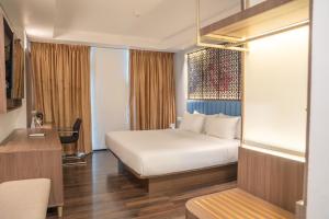 Postel nebo postele na pokoji v ubytování Akmani Hotel Jakarta